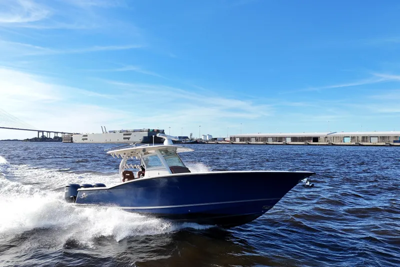  Yacht Photos Pics 2017 Scout 350 LXF boat cruising on open water under clear blue skies.