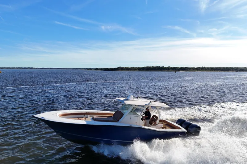  Yacht Photos Pics 2017 Scout 350 LXF boat cruising on open water under a clear blue sky.