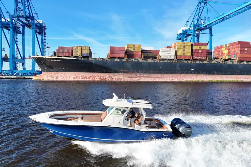  Yacht Photos Pics 2017 Scout 350 LXF boat cruising near container ship and cranes.