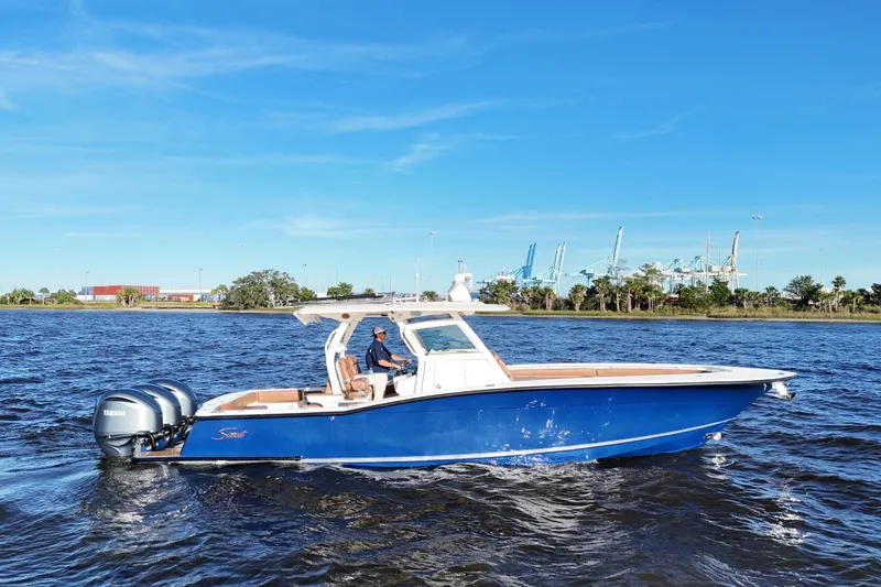  Yacht Photos Pics 2017 Scout 350 LXF boat cruising on water with blue sky background.