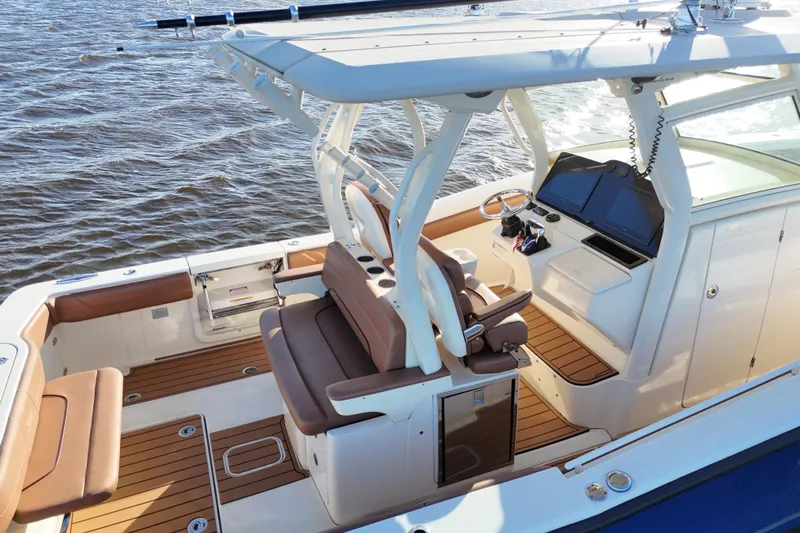 Yacht Photos Pics 2017 Scout 350 LXF boat interior with brown seating and modern dashboard on water.