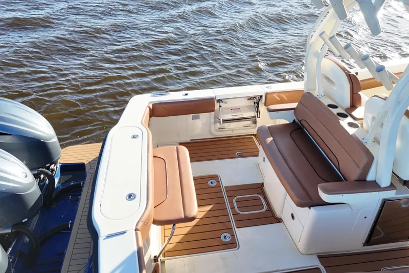  Yacht Photos Pics 2017 Scout 350 LXF boat interior with brown seating and dual engines on water.