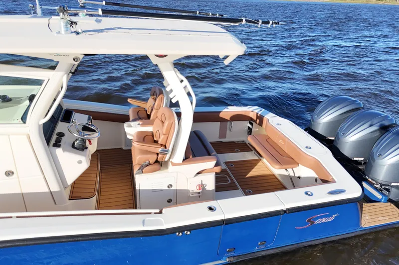 Yacht Photos Pics 2017 Scout 350 LXF boat with luxurious seating and triple outboard engines on the water.