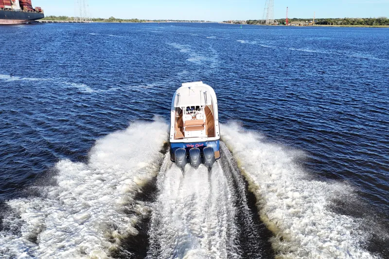  Yacht Photos Pics 2017 Scout 350 LXF boat cruising on open water, leaving a wake behind.