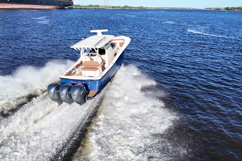  Yacht Photos Pics 2017 Scout 350 LXF boat cruising on open water with triple engines.