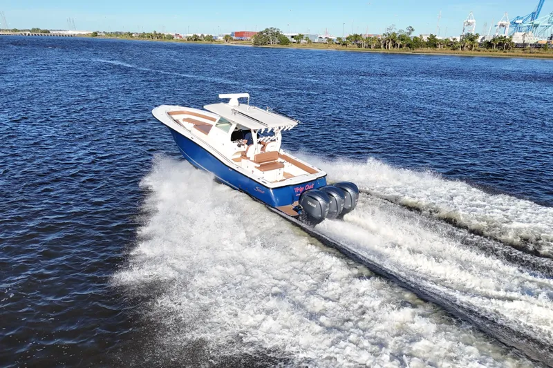  Yacht Photos Pics 2017 Scout 350 LXF boat cruising on open water with triple engines.