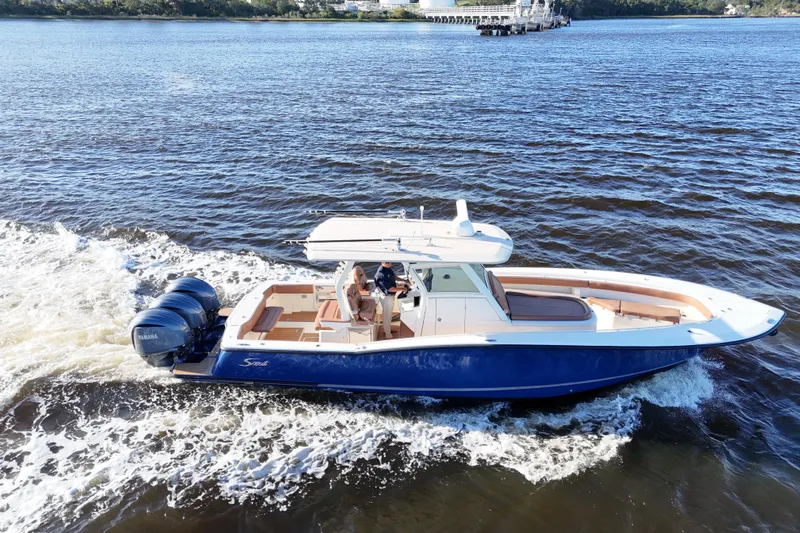  Yacht Photos Pics 2017 Scout 350 LXF boat cruising on a river with dual Yamaha engines.
