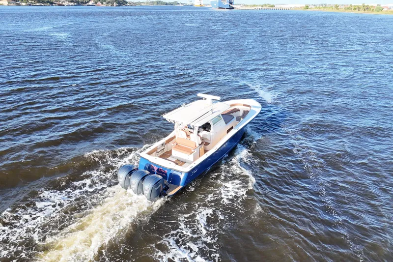  Yacht Photos Pics 2017 Scout 350 LXF boat cruising on open water, rear view.