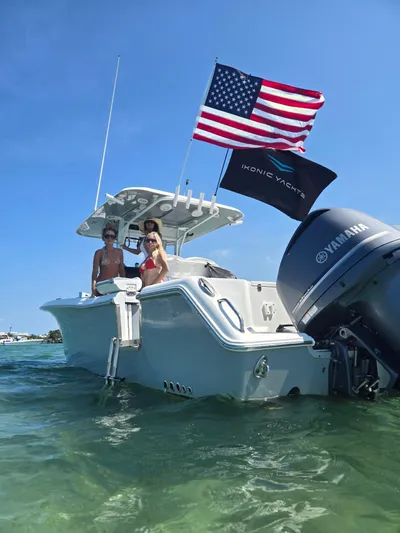 ___ Yacht Photos Pics 2018 Sea Hunt Gamefish 30 with flags, anchored in clear water.