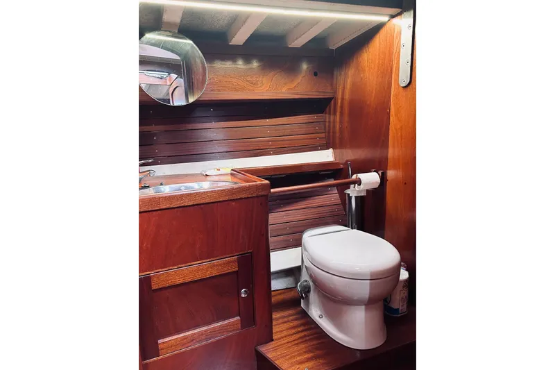 Aria Di Mare Yacht Photos Pics 2013 Custom Classic Yawl bathroom with wooden interior, featuring a toilet and sink.