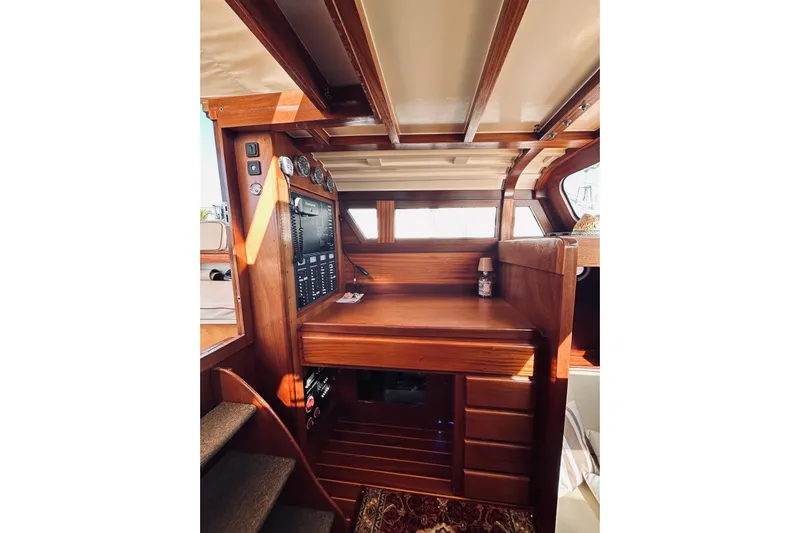 Aria Di Mare Yacht Photos Pics Interior of 2013 Custom Classic Yawl with wooden navigation station and control panel.