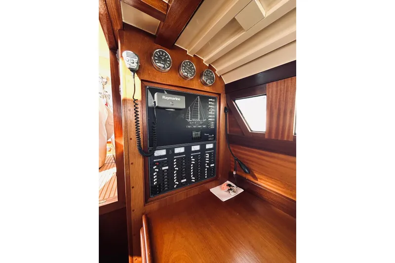 Aria Di Mare Yacht Photos Pics Control panel of a 2013 Custom Classic Yawl with Raymarine equipment and wooden interior.