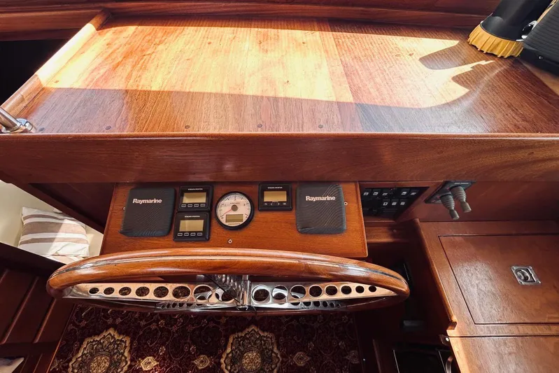 Aria Di Mare Yacht Photos Pics Wooden helm of 2013 Custom Classic Yawl with Raymarine instruments and elegant design.