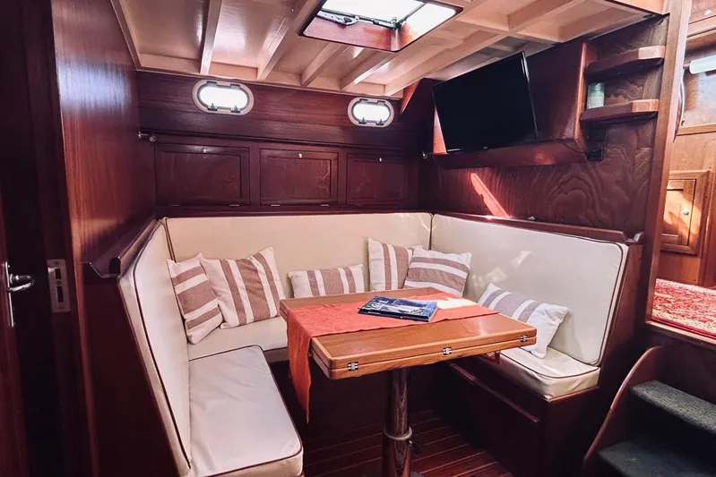 Aria Di Mare Yacht Photos Pics Interior of 2013 Custom Classic Yawl with cozy seating and wooden accents.