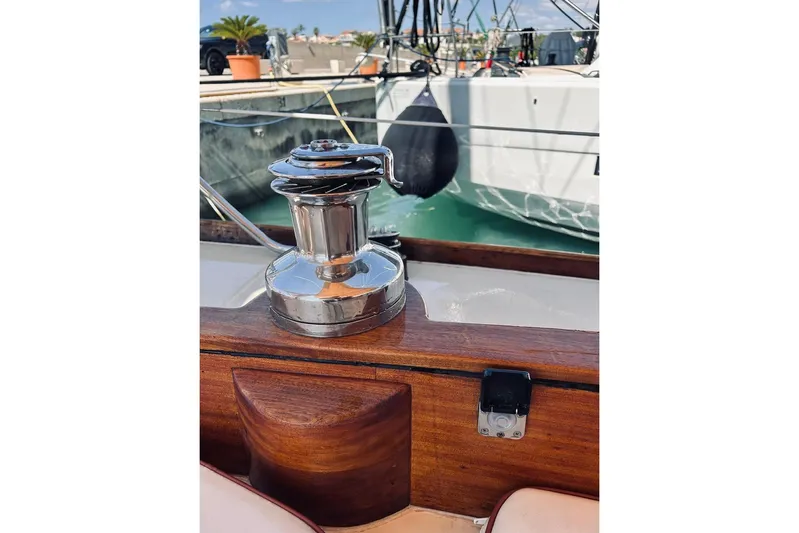 Aria Di Mare Yacht Photos Pics Polished winch on 2013 Custom Classic Yawl with wooden deck, docked at marina.