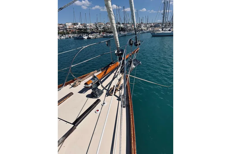 Aria Di Mare Yacht Photos Pics Custom Classic Yawl sailboat, 2013 model, docked in a marina with clear blue water.