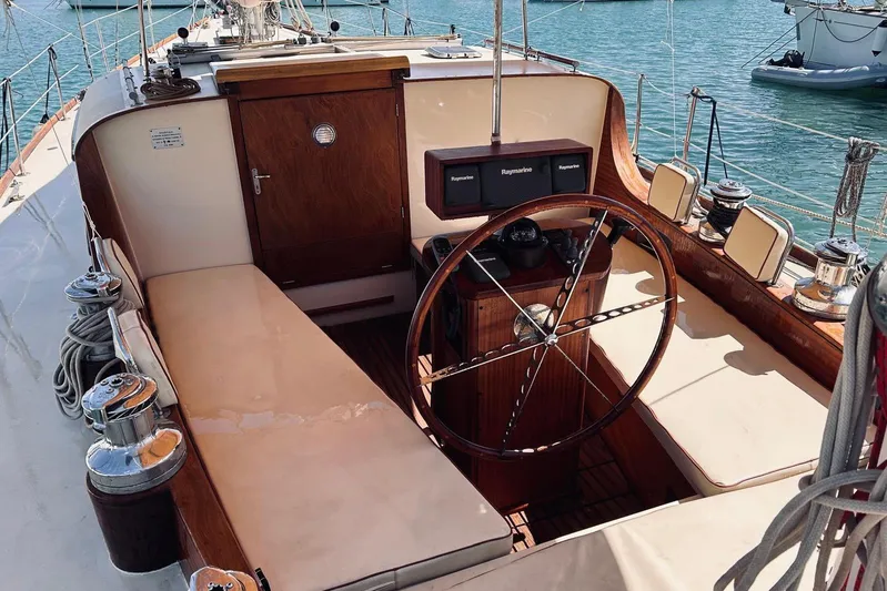 Aria Di Mare Yacht Photos Pics Cockpit of a 2013 Custom Classic Yawl with wooden accents and steering wheel.