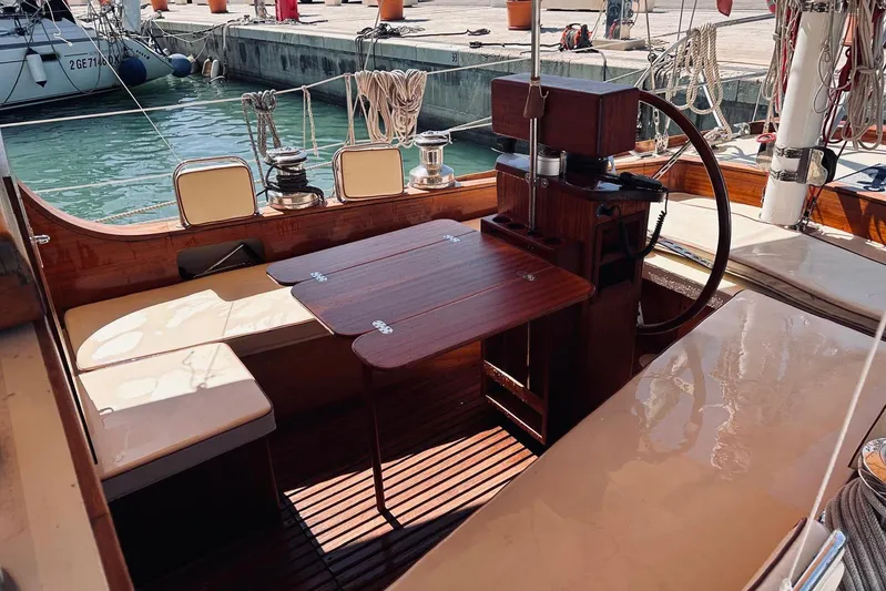 Aria Di Mare Yacht Photos Pics Classic 2013 Custom Yawl interior with wooden table and seating at marina.
