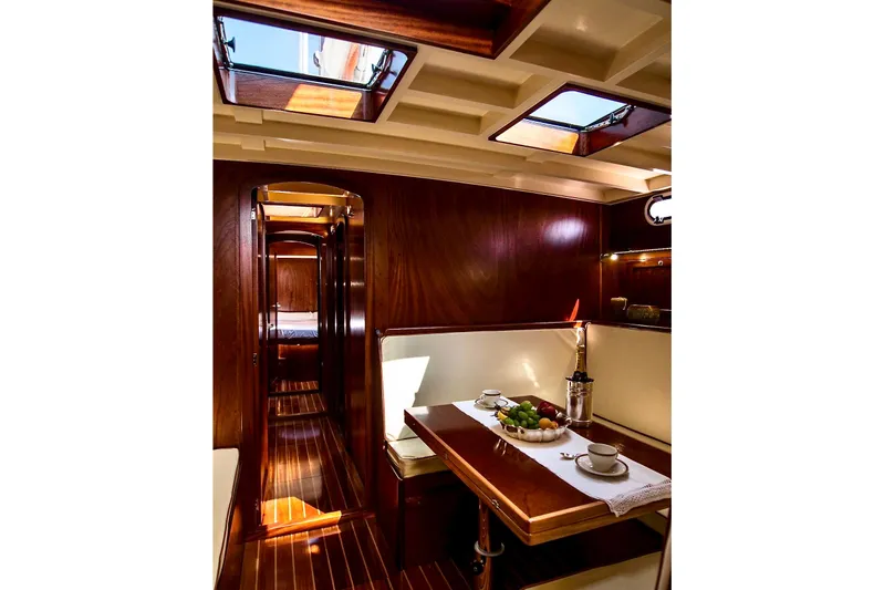 Aria Di Mare Yacht Photos Pics Luxurious interior of 2013 Custom Classic Yawl with elegant wood finish and dining area.