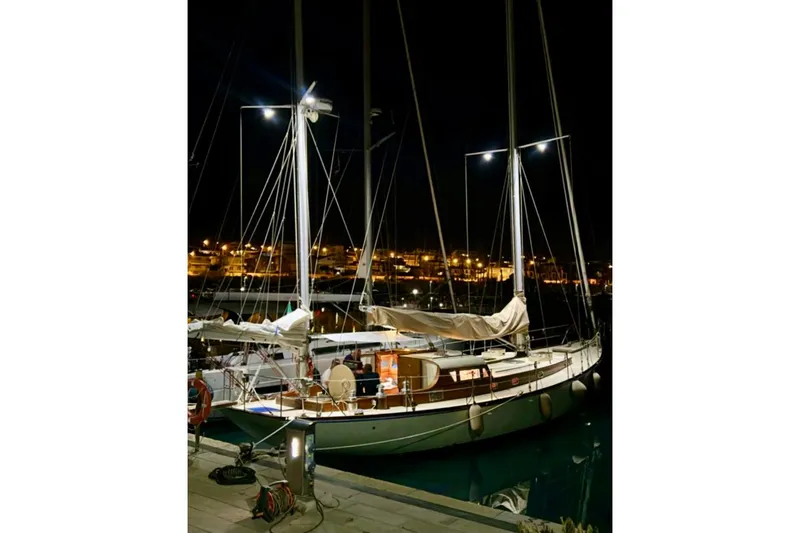 Aria Di Mare Yacht Photos Pics Custom Classic Yawl 2013 docked at night, illuminated by dock lights.
