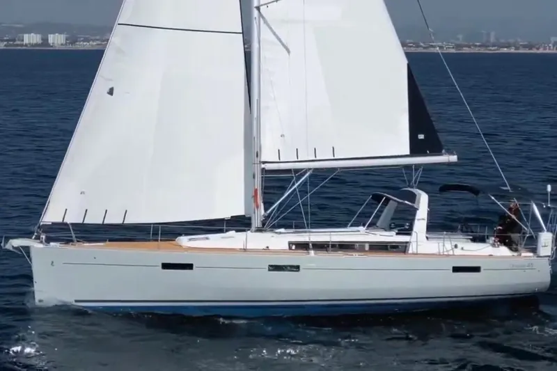 Bella Yacht Photos Pics 2017 Beneteau Oceanis 45 sailing on open water, showcasing sleek design and white sails.