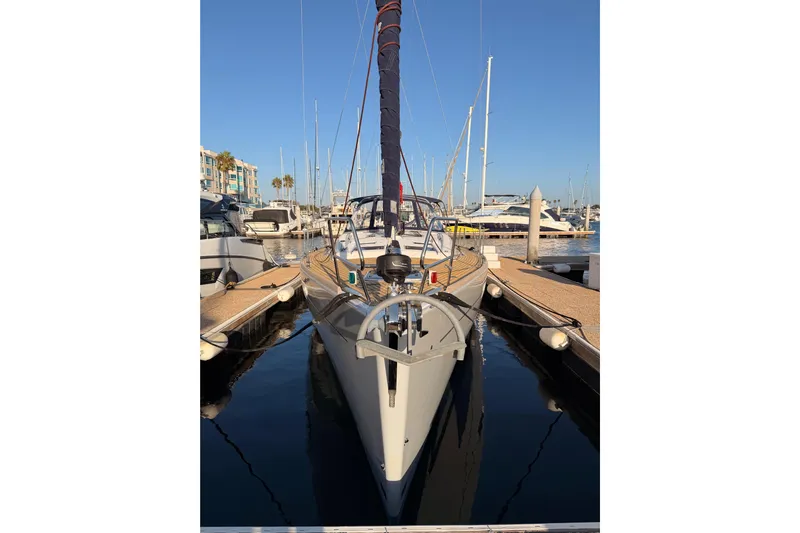 Bella Yacht Photos Pics 2017 Beneteau Oceanis 45 sailboat docked in a marina under clear blue skies.