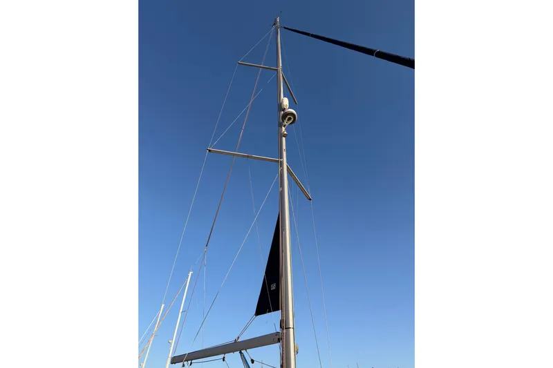 Bella Yacht Photos Pics Mast of 2017 Beneteau Oceanis 45 sailboat against clear blue sky.