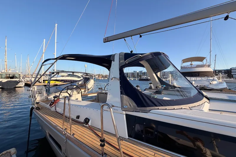 Bella Yacht Photos Pics 2017 Beneteau Oceanis 45 sailboat docked in marina, featuring sleek design and spacious deck.