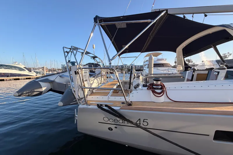 Bella Yacht Photos Pics 2017 Beneteau Oceanis 45 yacht docked at marina, featuring sleek design and spacious deck.