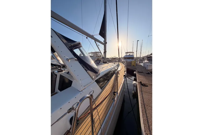 Bella Yacht Photos Pics 2017 Beneteau Oceanis 45 yacht docked at marina during sunset.