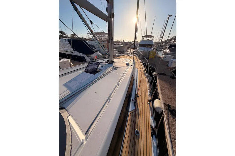 Bella Yacht Photos Pics 2017 Beneteau Oceanis 45 sailboat docked at marina during sunset.