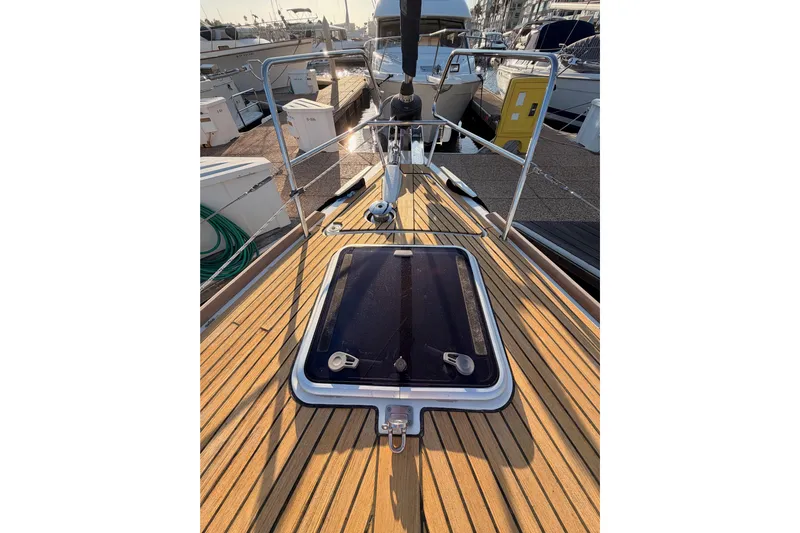 Bella Yacht Photos Pics Beneteau Oceanis 45 (2017) yacht deck with wooden finish and hatch.