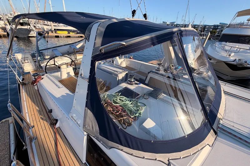 Bella Yacht Photos Pics 2017 Beneteau Oceanis 45 sailboat with blue canopy docked at marina.