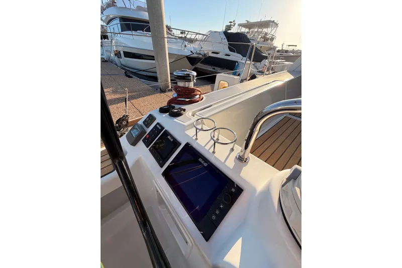 Bella Yacht Photos Pics Cockpit view of 2017 Beneteau Oceanis 45 sailboat with navigation equipment and marina backdrop.