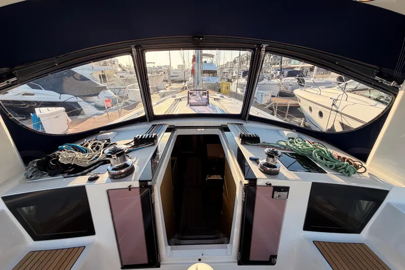 Bella Yacht Photos Pics Cockpit view of 2017 Beneteau Oceanis 45 yacht, showcasing winches and marina surroundings.