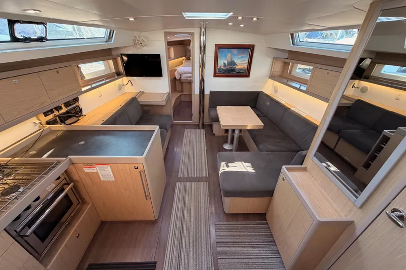 Bella Yacht Photos Pics Luxurious interior of 2017 Beneteau Oceanis 45 yacht with modern kitchen and seating area.