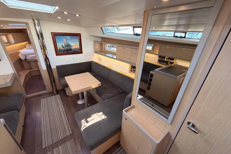 Bella Yacht Photos Pics Interior of 2017 Beneteau Oceanis 45 yacht, featuring modern seating and kitchen area.