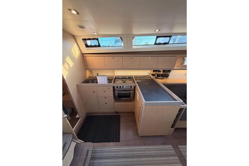 Bella Yacht Photos Pics Modern kitchen interior of 2017 Beneteau Oceanis 45 yacht with sleek cabinetry and appliances.