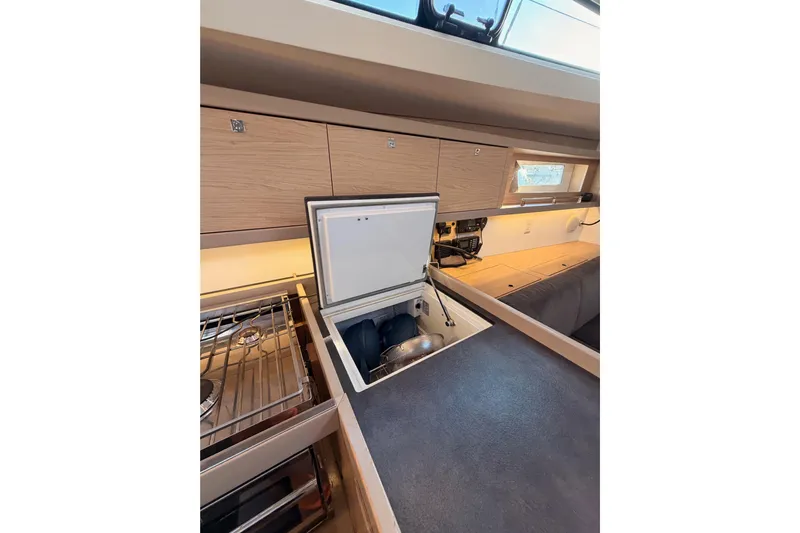 Bella Yacht Photos Pics Interior of 2017 Beneteau Oceanis 45 yacht kitchen with open storage compartment.