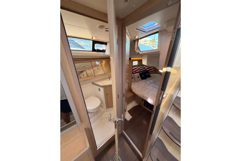 Bella Yacht Photos Pics Interior of 2017 Beneteau Oceanis 45 yacht showing cabin and bathroom.
