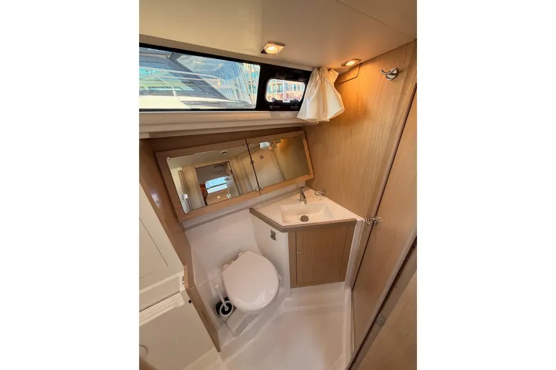 Bella Yacht Photos Pics 2017 Beneteau Oceanis 45 yacht bathroom with sink, mirror, and toilet.
