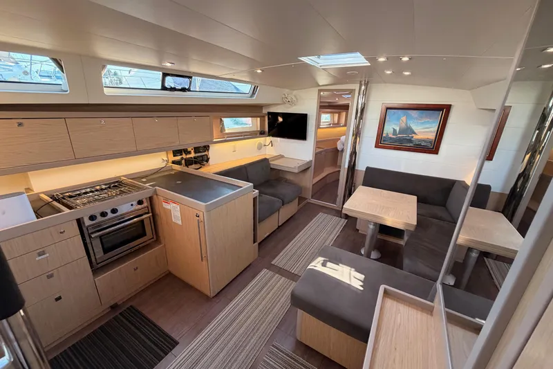 Bella Yacht Photos Pics Interior of 2017 Beneteau Oceanis 45 yacht with modern kitchen and seating area.