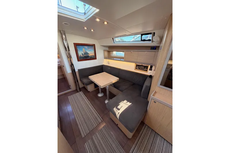 Bella Yacht Photos Pics Interior of 2017 Beneteau Oceanis 45 yacht with cozy seating and modern decor.