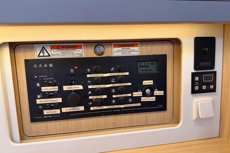 Bella Yacht Photos Pics Control panel of a 2017 Beneteau Oceanis 45 sailboat with various switches and warnings.