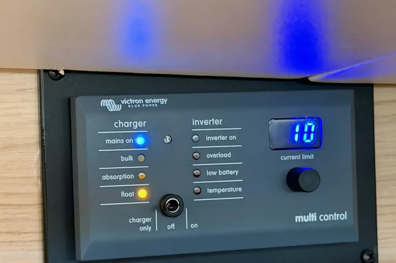 Bella Yacht Photos Pics Control panel of a 2017 Beneteau Oceanis 45 yacht, featuring Victron Energy charger and inverter.