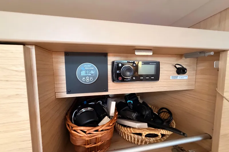 Bella Yacht Photos Pics Interior of 2017 Beneteau Oceanis 45 yacht with control panel and storage baskets.