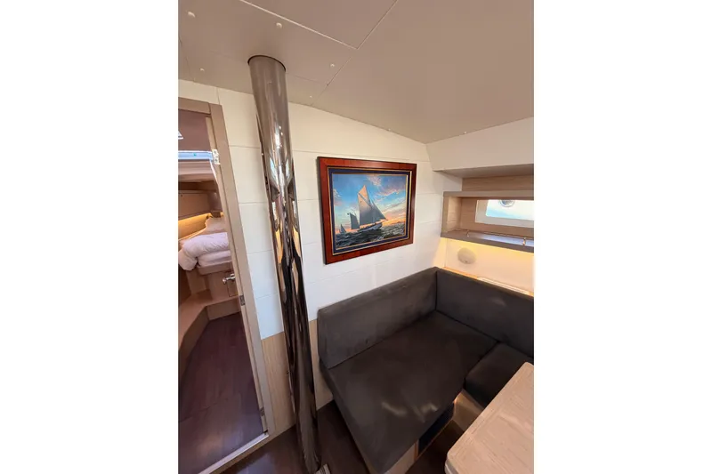Bella Yacht Photos Pics Interior of 2017 Beneteau Oceanis 45 yacht with cozy seating and nautical artwork.