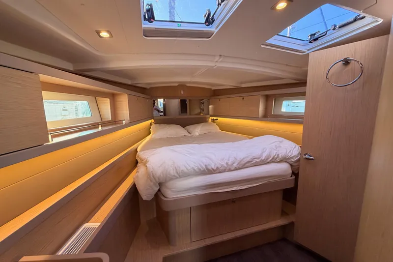Bella Yacht Photos Pics Luxurious cabin interior of 2017 Beneteau Oceanis 45 yacht with skylights and cozy bedding.