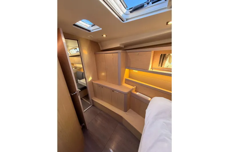 Bella Yacht Photos Pics Interior of 2017 Beneteau Oceanis 45 yacht, featuring modern wood cabinetry and skylight.