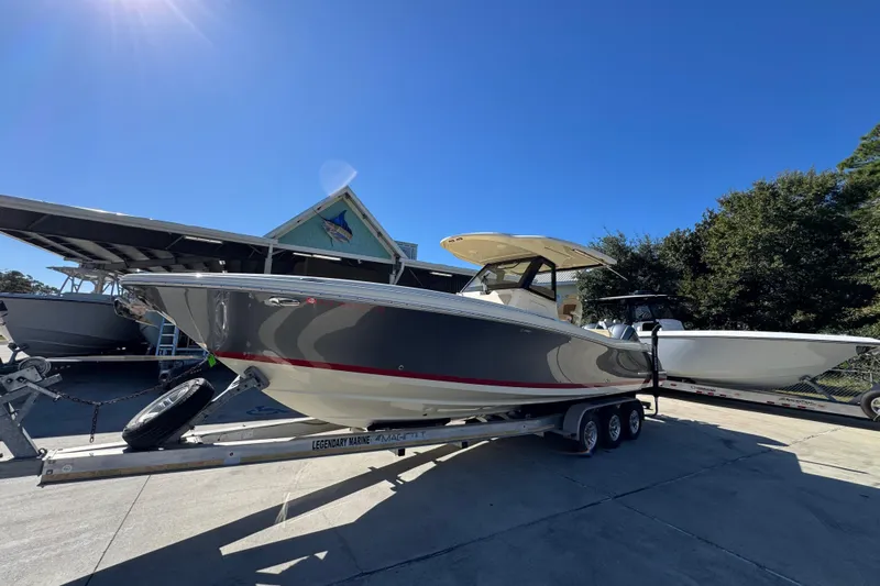  Yacht Photos Pics 2019 Chris-Craft Catalina 30 boat on trailer under clear blue sky.